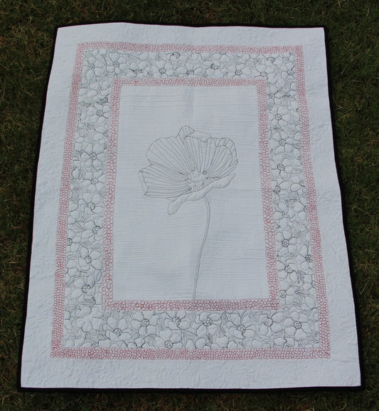 Back of Poppy wall hanging showing quilting. Stitched so that poppy and surrounding boarders are visible.