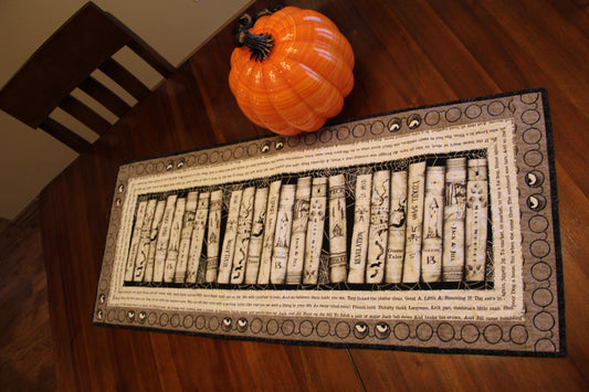 Gray Scary Books Table Runner on a table.